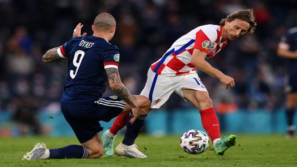 Scotland's Lyndon Dykes challenges Croatia's Luka Modric